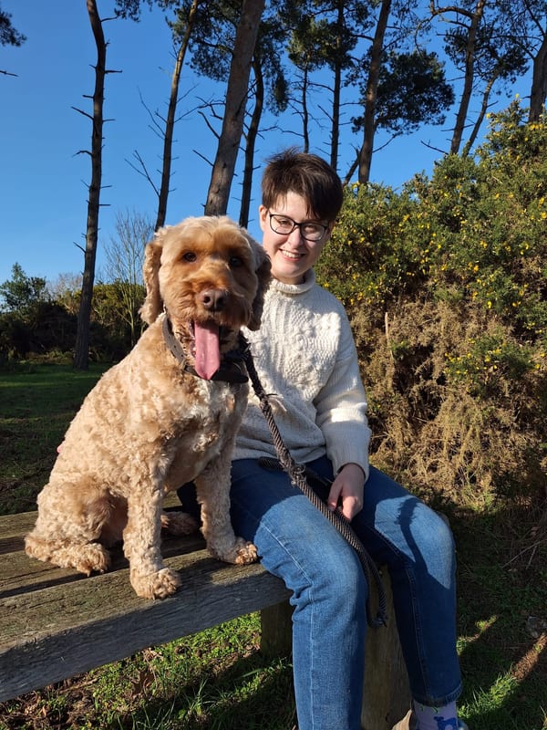 Iona with a dog outdoors in the countryside
